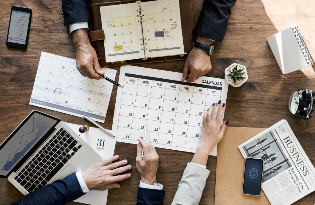 Group of corporate executives planning dates for an event