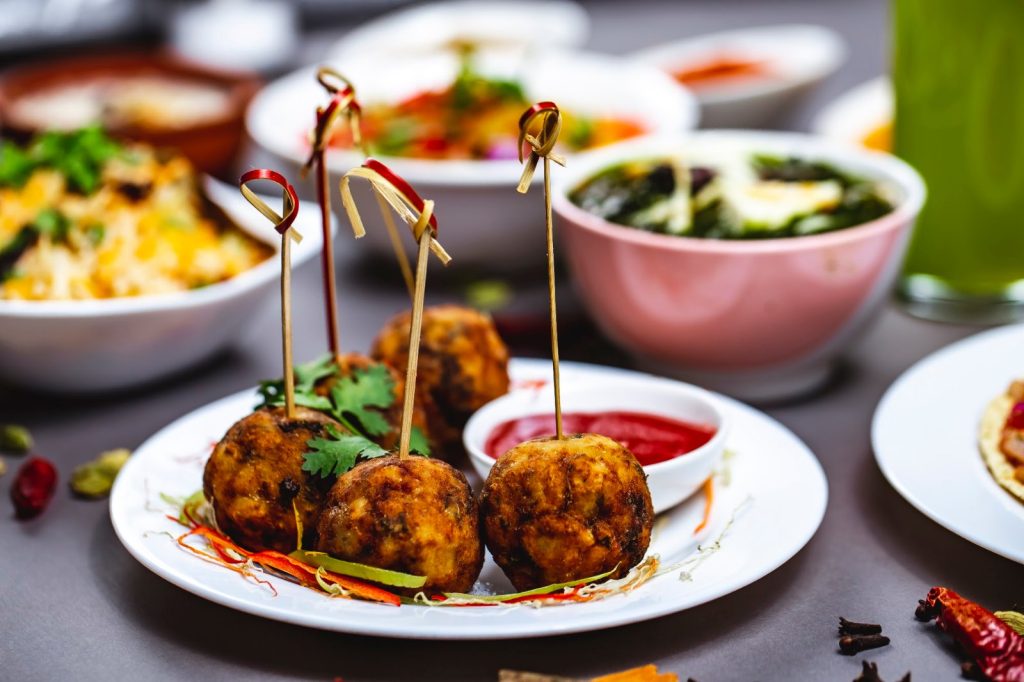 A plate of festive snacks served at an office Diwali celebration