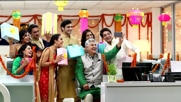 Employees enjoying an office Diwali celebration with festive décor, games and activities.